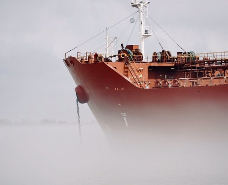 Image of the bow of a Hazmasters Shipping vessel at sea.